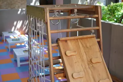 a wooden ladder with a wooden door in a room at Adi Dharma Hotel Kuta in Kuta