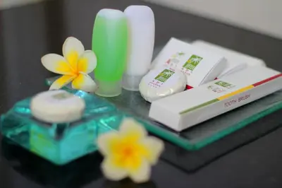 a table topped with a tray with products and flowers at Adi Dharma Hotel Legian in Legian