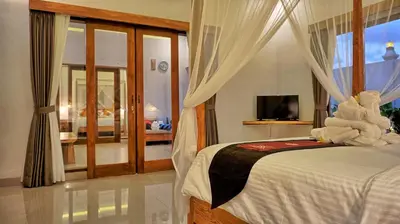 a bedroom with a bed with white towels on it at Sarayu Villa in Seminyak