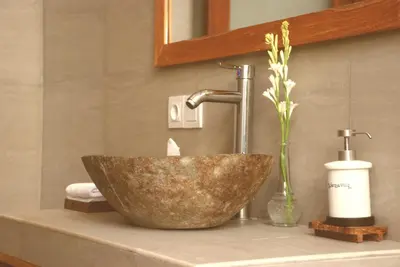 a bathroom sink with a bowl shaped sink at Sarayu Villa in Seminyak
