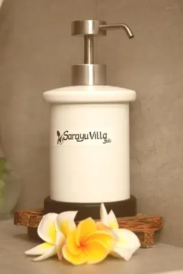 a slow cooker and a flower on a table at Sarayu Villa in Seminyak