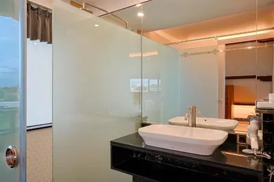 a bathroom with a sink and a mirror at Kyara Villa Apartments in Canggu