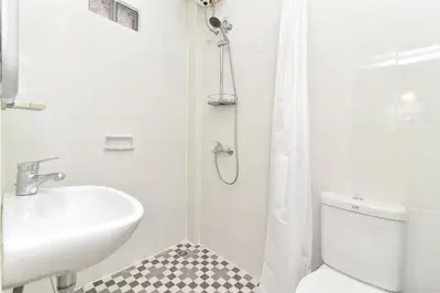 a bathroom with a sink and a toilet and a shower at RedDoorz Plus near Jalan Imam Bonjol Denpasar in Seminyak