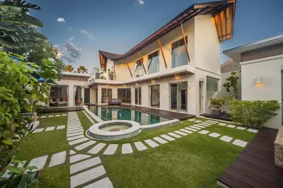 an exterior view of a house with a swimming pool at Luxury Villa Juno Seminyak in Seminyak