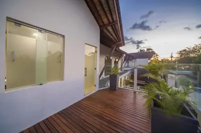 a wooden deck with plants on a house at Luxury Villa Juno Seminyak in Seminyak