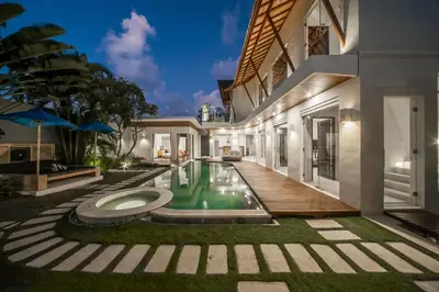 an exterior view of a house with a swimming pool at Luxury Villa Juno Seminyak in Seminyak