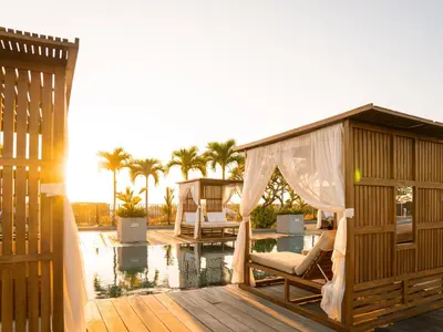 a pool with a gazebo next to a house at Cross Paasha Bali Seminyak in Seminyak
