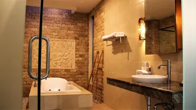 a bathroom with a sink and a toilet and a shower at The Nibbana Villas in Seminyak
