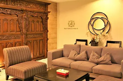 a living room with a couch and a table at The Nibbana Villas in Seminyak