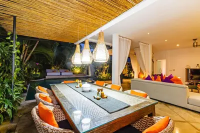 a living room with a dining table and chairs at Villa Eindra Seminyak in Seminyak
