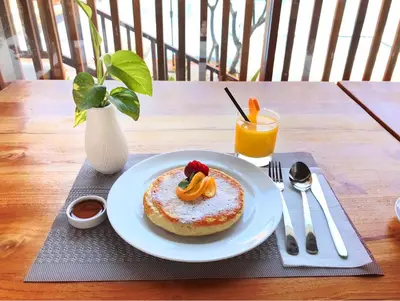 a plate with a pastry on a table with a drink at The Salila Beach Resort in Seminyak