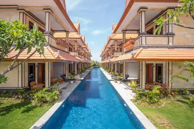 an alley between two buildings with a swimming pool at The Salila Beach Resort in Seminyak
