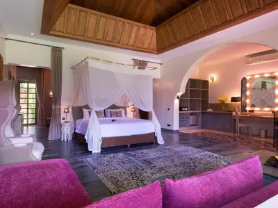 a bedroom with a large bed with a canopy at Sayang d'Amour in Seminyak