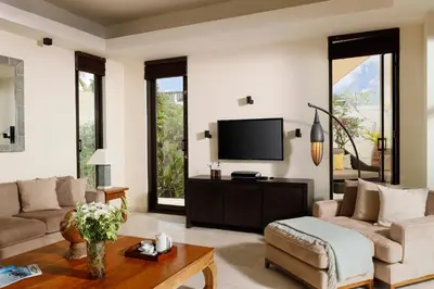 a living room with a couch and a tv at Villa Jamalu by Nakula in Jimbaran
