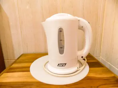 a white mixer sitting on top of a wooden table at Guna Graha Kuta by Kamara in Kuta