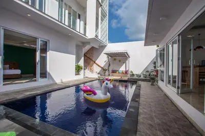 a swimming pool with a rubber duck in the middle of a house at Villa Ultima Umalas in Canggu