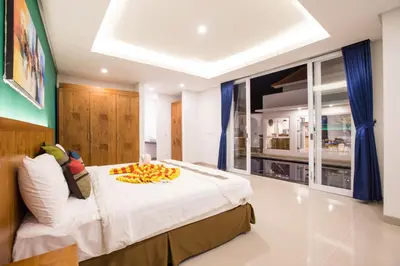 a bedroom with a bed with a bowl of fruit on it at Villa Ultima Umalas in Canggu