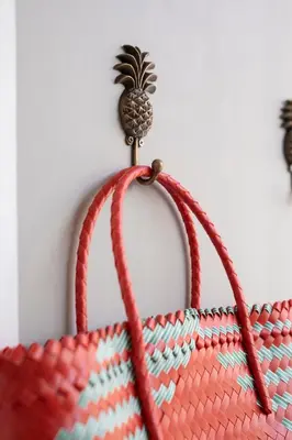 a basket with a pineapple attached to a wall at Villa Karang in Seminyak