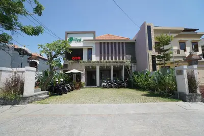 a building with bikes parked in front of it at Capital O 2166 Elitya Stay in Sanur