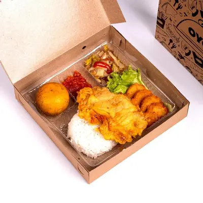 a box of food with rice and other foods at Capital O 2166 Elitya Stay in Sanur