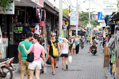 a group of people walking down a busy city street at XOXO Kuta Legian Hostel in Legian
