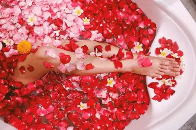 a person laying in a plate covered in flowers at b Hotel Bali & Spa in Denpasar