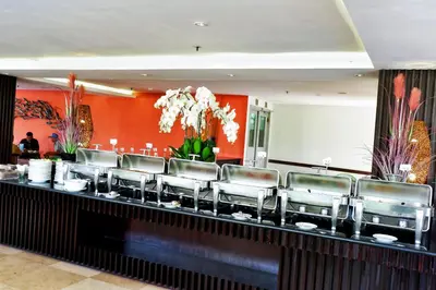 a bar with leather chairs at a restaurant at b Hotel Bali & Spa in Denpasar