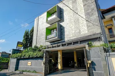 a building with green windows and plants on it at RedDoorz @ Kerta Dalem Sidakarya in Denpasar