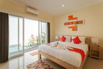 a bedroom with a large bed and a large window at Villa Julie & Villa Sydney, Seminyak - 2 Bedroom Modern Pool Villas! in Seminyak
