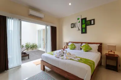 a bedroom with a bed with two swans on it at Villa Julie & Villa Sydney, Seminyak - 2 Bedroom Modern Pool Villas! in Seminyak