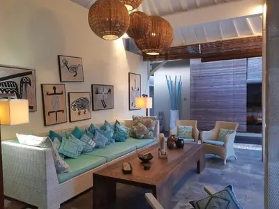 a living room with a couch and a table at Villa Sukapadi in Seminyak