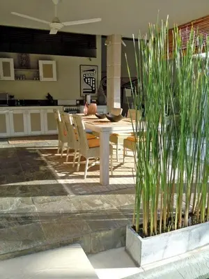 a patio with a table and chairs and a dining room at Villa Sukapadi in Seminyak