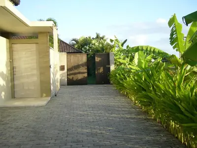 a driveway leading to a house with a garage at Villa Sukapadi in Seminyak