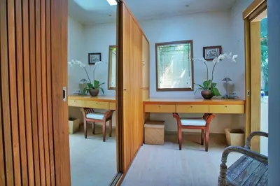 a hallway with two desks with chairs and a window at Villa Bali Asri Batubelig in Seminyak