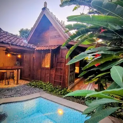 a house with a swimming pool in front of a house at Villa BAgus - near Seminyak beach & trendy shops, restaurants, cafes in Seminyak
