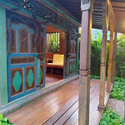 an outside porch of a house with a wooden deck at Villa BAgus - near Seminyak beach & trendy shops, restaurants, cafes in Seminyak