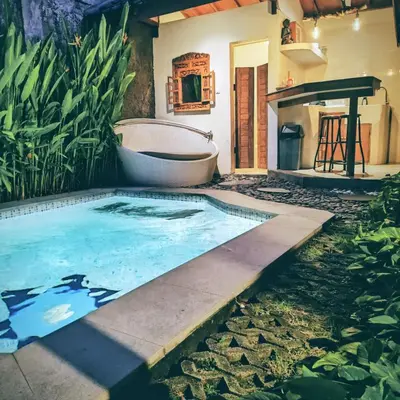 a bath tub sitting next to a bathroom with a bath tub at Villa BAgus - near Seminyak beach & trendy shops, restaurants, cafes in Seminyak