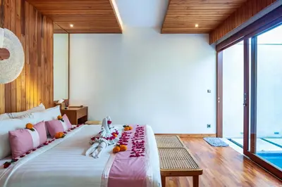 a bedroom with a large bed with stuffed animals on it at Bali Vilaasee in Seminyak