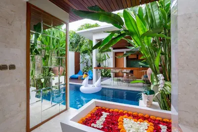 a pool in the middle of a house at Bali Vilaasee in Seminyak