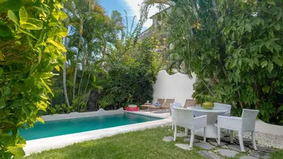 a backyard with a pool and a table and chairs at Ocean Luxury Villas - Private Pool Seminayk in Seminyak