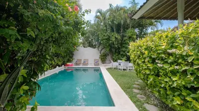 a swimming pool in a yard with plants at Ocean Luxury Villas - Private Pool Seminayk in Seminyak