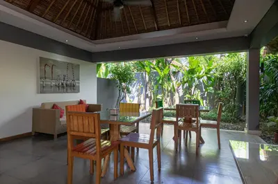 a dining room with a table and chairs at Balinea Holiday Home in Kerobokan