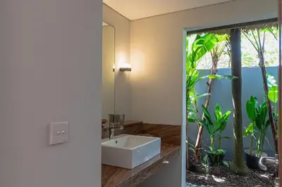 a bathroom with a sink and a mirror at Balinea Holiday Home in Kerobokan