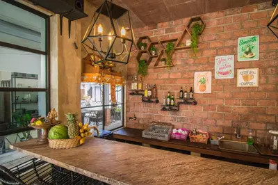a brick wall with a counter in a restaurant at Gemini Star Hotel Kuta in Kuta