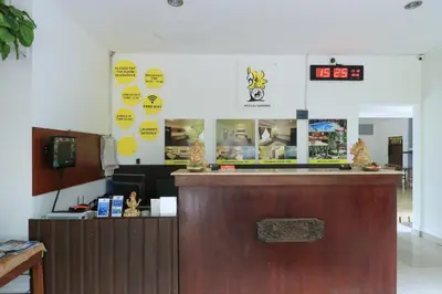 a bar in a restaurant with a counter in a room at Ayu Lili Garden Hotel Kuta in Kuta