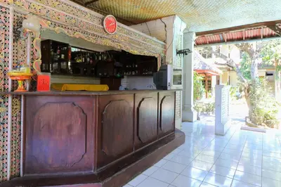 a wooden bar in an outdoor area with at Sari Bali Resort in Kuta