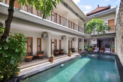a swimming pool in the courtyard of a house with plants at Angkul Angkul Segara Beach Kuta by Kamara in Kuta