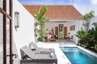 a villa with a swimming pool and a house at Villa Salsa in Seminyak