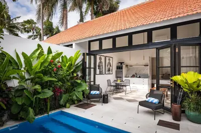 a villa with a swimming pool and a house at Villa Chino in Seminyak