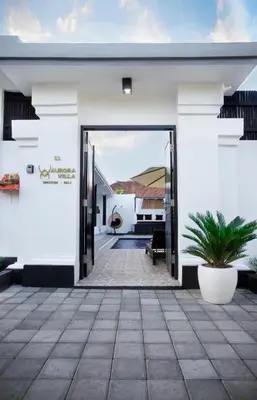 an open door to a house with a courtyard at Aurora Villa, Seminyak in Seminyak